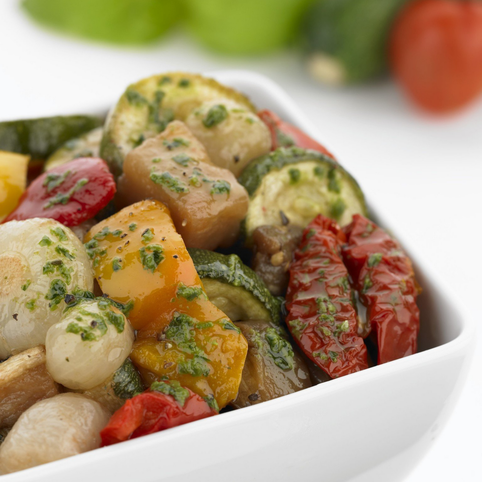 Line Cook Wearing A Striped Apron And A Black Bandana Cutting A Vegetable Next To Two Other Cooks